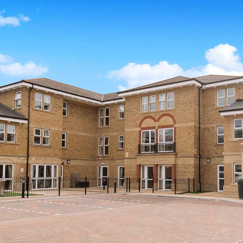 Sand brick three storey building complex and driveway